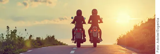 Two motorcycle enthusiasts in the morning sun on the way to the biker arrangement